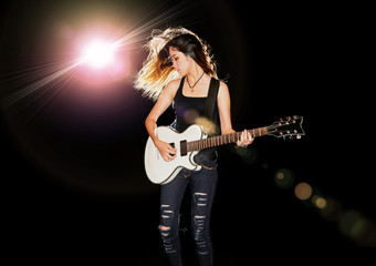Young and beautiful rock girl playing the electric guitar - obrazy, fototapety, plakaty