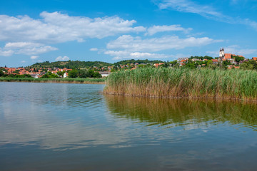 Obraz premium Tihany abbey and the village at lake Balaton viewed from the inner laker with reed in Hungary