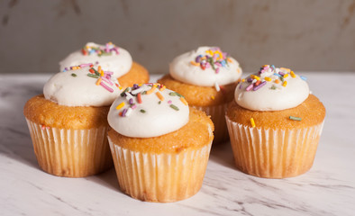 vanila cupcakes on granite surface