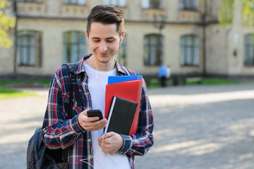 Closeup photo portrait of cheerful positive delightful nice handsome glad millennial choosing song on his mp3 player