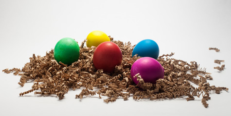 Fototapeta na wymiar colorful easter eggs on brownconfetti