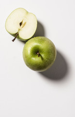 two apples one cut in half