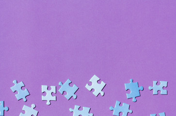Puzzle pieces on a purple background.
