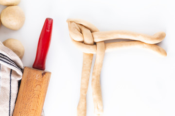 Homemade food concept process braiding bread braid challah dough on white background with copy space