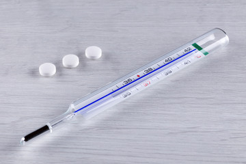 Tablets and a medical thermometer.