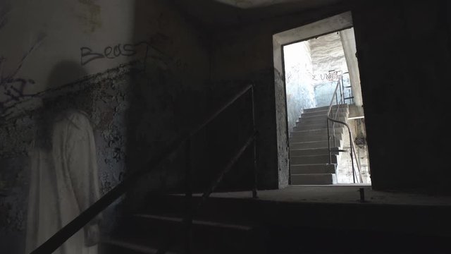 A ghost of a woman wanders the stairs of an old abandoned building.