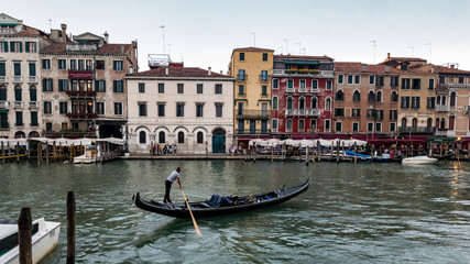 Gondolier moving the gondola through the Venice canal © Heather