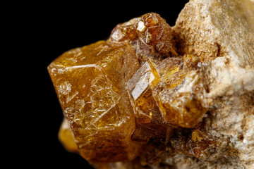 Macro stone Grossular mineral on a black background