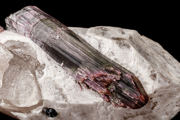 Macro stone tourmaline mineral on a black background close up