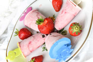 Homemade vanilla and strawberry ice cream served.