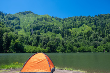 Camping tent at scenic campsite on a lake
