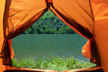 Camping tent at scenic campsite on a lake