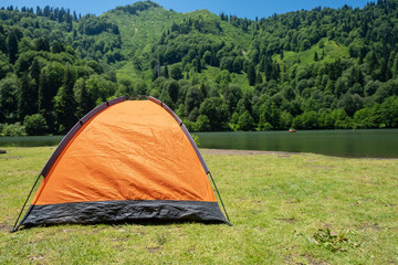 Camping tent at scenic campsite on a lake
