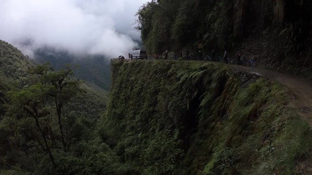 Bus loaded with bicycles moves on the famous Death Road in Bolivia