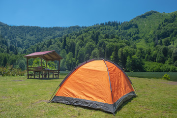 Camping tent at scenic campsite on a lake