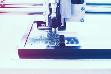 Automated manufacturing process for boards or microchips for electronics or computers.