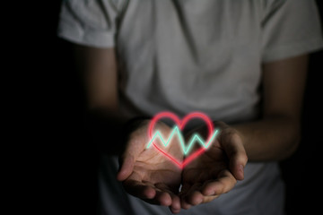 Heart with fluctuating lines on a man's hands