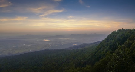 Mountain view panorama 180 degree morning on top hill around with soft fog with yellow sun light in the sky background, sunrise at Nok Aen Cliff View Point, Phu Kradueng National Park, Loei, Thailand.