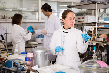 Female lab technician working with reagents