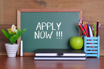 Green school chalkboard with written sentence APPLY NOW