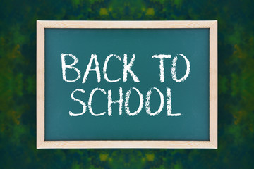 Obraz premium Chalkboard with text BACK TO SCHOOL on dark green background