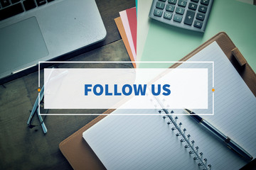 Notebook and Laptop with text FOLLOW US