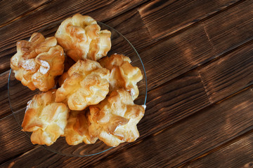 Pastry filled with custard on the table of wooden pine planks