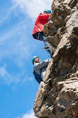 Young hikers climb on the ferrata Piz Trovat. Morteratsch Glacier. Panorama of Piz Bernina in Swiss Alpes.