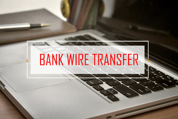 Notebook and Laptop with text BANK WIRE TRANSFER