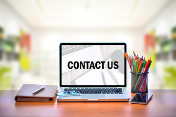 Open laptop with isolated white screen on old wooden desk with text CONTACT US