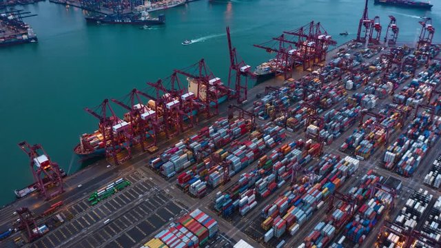 Hyperlapse of Aerial view of container cargo ship in export and import business and logistics international goods. Shipping to the harbor by crane in Victoria Harbour, Hong Kong City at night.