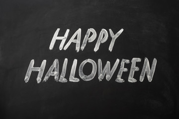 Fototapeta premium Happy Halloween made with chalk on a blackboard.