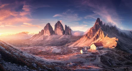 Wall murals Dolomites Mountain valley with beautiful house and church at sunset in autumn. Landscape with buildings, high rocks, colorful sky, clouds, sunlight. Mountains in Tre Cime park in Dolomites, Italy. Italian alps