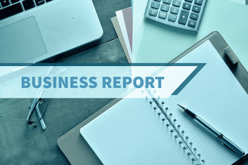 Notebook and Laptop with graph and charts. Financial Concept with word Business Report