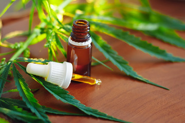 Bottle of Hemp CBD oil. Medical marijuana products including cannabis leaf, CBD and hash oil,...