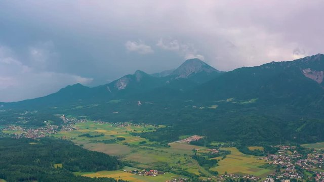 VILLACH, AUSTRIA - JUNE, 2019: Aerial drone view of Villach suburb with beautifil nature. Roads and railroads from above