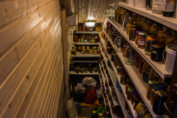 .Home cellar food storage room. Many jars with Canning Fruits and Vegetables on shelves