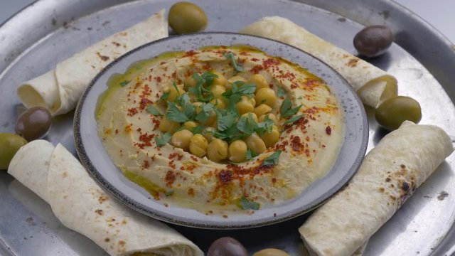 Dish with hummus, pita and olivs.Top view