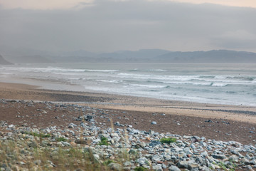 Sunset and fog at a surf bay in northern Spain