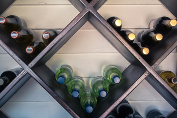 Wine bottles on a rack getting better with time.