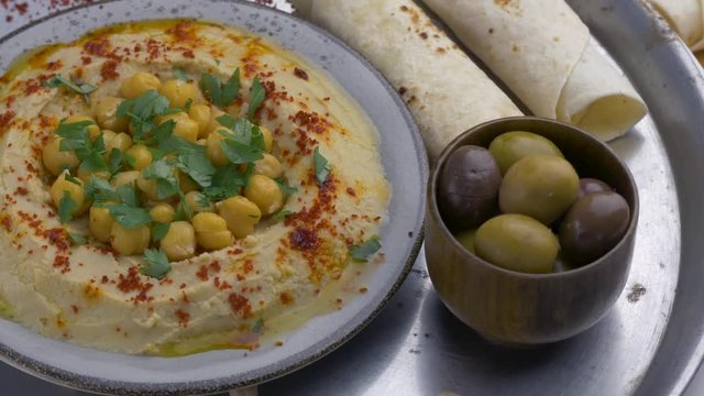 Dish with hummus, pita and olivs.Top view