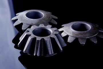 Gears, bearings and differential stars lie on the table close-up
