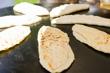 Traditional turkish food gozleme baked on iron stove. 