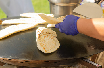 Traditional turkish food gozleme baked on iron stove. 