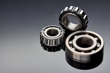 Close-up of a set of ball and roller bearings on a dark background