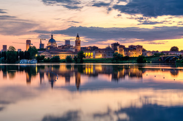 View of the city of Mantua at sunset reflected on the Middle Lake on the Mincio River