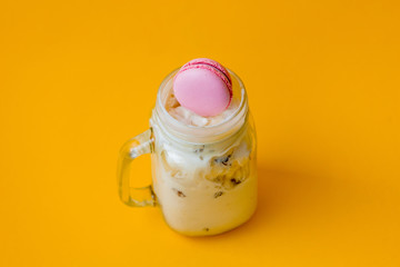 Cream ice-cream with macaron in glass cup