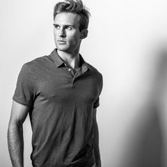 Elegant young handsome man in classic shirt. Black-white portrait.