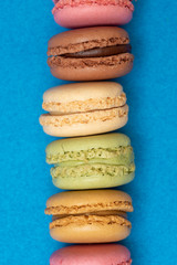 Colorful macaroons over a colored bakcground