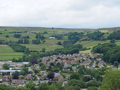 a view of mytholmroyd from above in west yorkshire countryside surrounded by trees and fields and farms